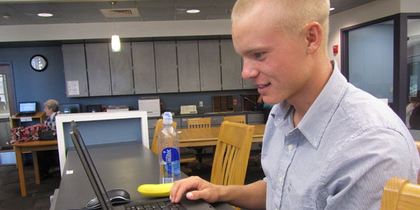 Christian Horn (12) studies in the library while finishing up his lunch, Sep 6. 
