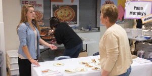 Kelsey Knobbe (12) volunteers at Taste of the town for the Papa Murphy's stand.