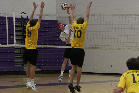 Austin Trower, setter, hits the ball past the block during the game against Oakville, April 4. 