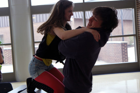 Emily Wildenhaus (10) and Nick Vogel (11) practice their lines and blocking for the Senior One Act Hard Candy directed by Dan Roesch (12) outside the small theater after school, April 14.