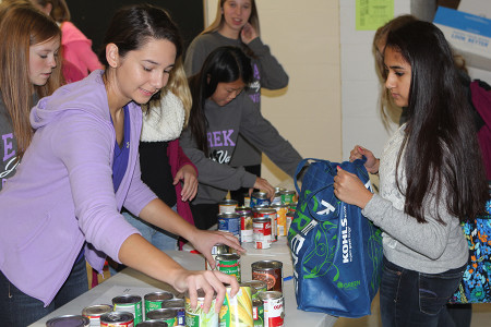 Audrey Dames, StuCo member, counts the items brought in by Pushti Pryia Shah (10), Nov. 6.