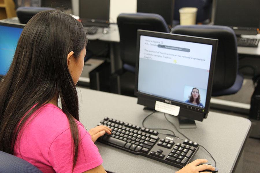 Dani Ridinger (11) watches a video posted for Mrs. Cynthia Sieloffs Honors Algebra 2 class, Oct. 24.