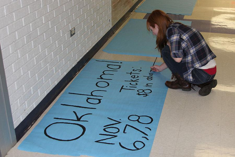Katherine Miller, House Manager and publicist crew member, creates signs to promote the musical Oklahoma around school, Oct. 29.