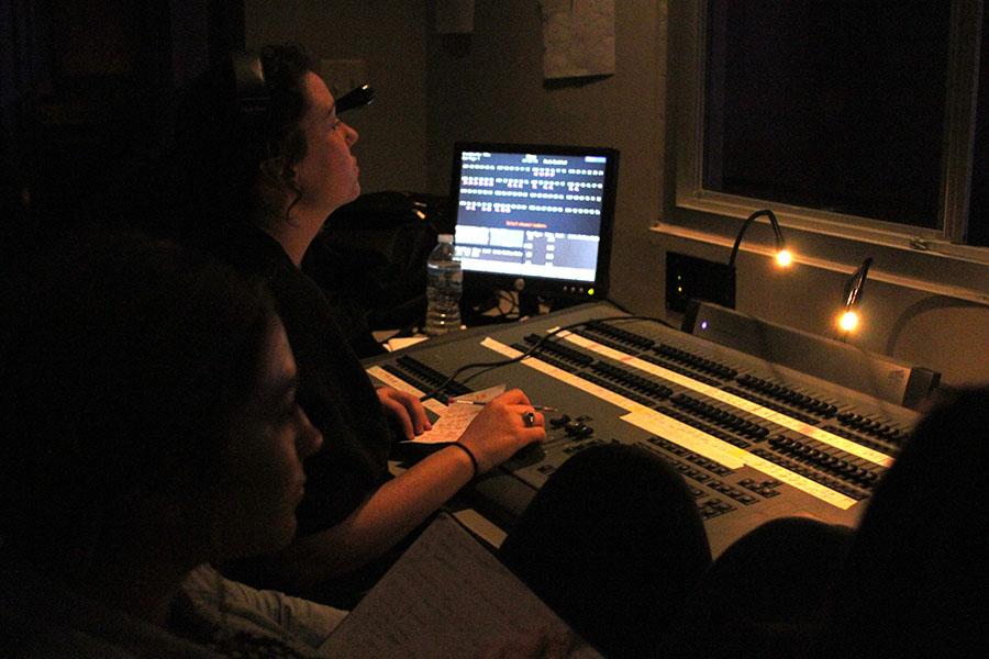 Melissa Schmitt and Madison Hadler work the lights as they watch the stage, Oct. 29.