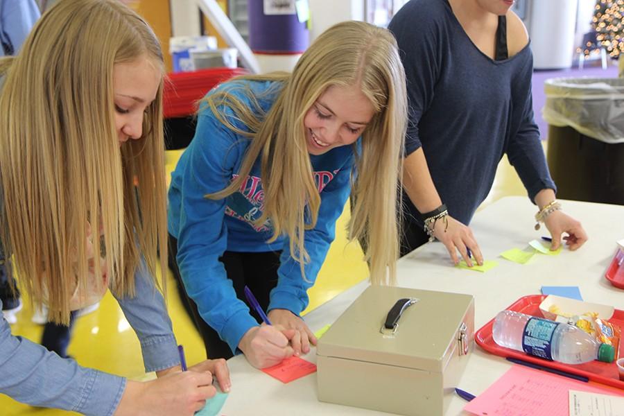 Kathryn Creason and Ellie Baker (10) writing kind words on sticky notes during Kindness Week, Dec. 8.