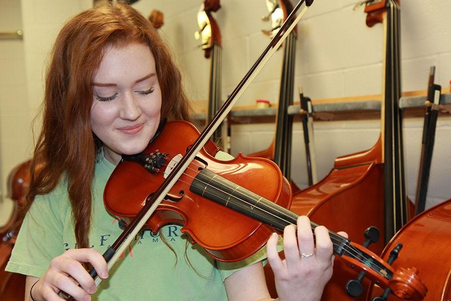 Natalie Bishop (9) plays her violin in the orchestra room