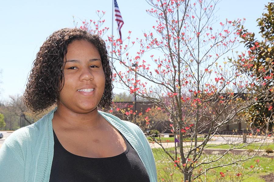 Abriela Bogan (11) is passionate about politics as she stands in front of the American flag, April 12.