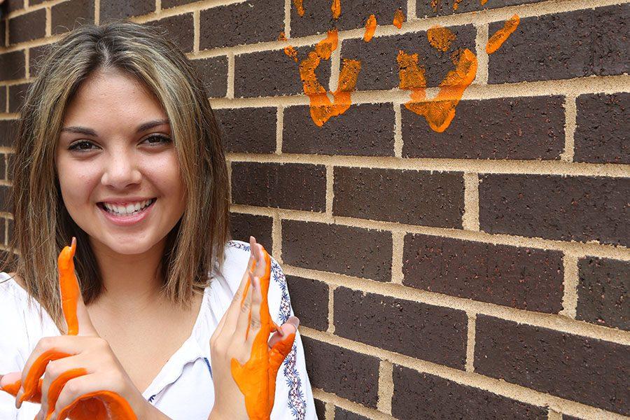 Lauren Dell leaves her mark on the wall outside the EHS-hub, May 11.