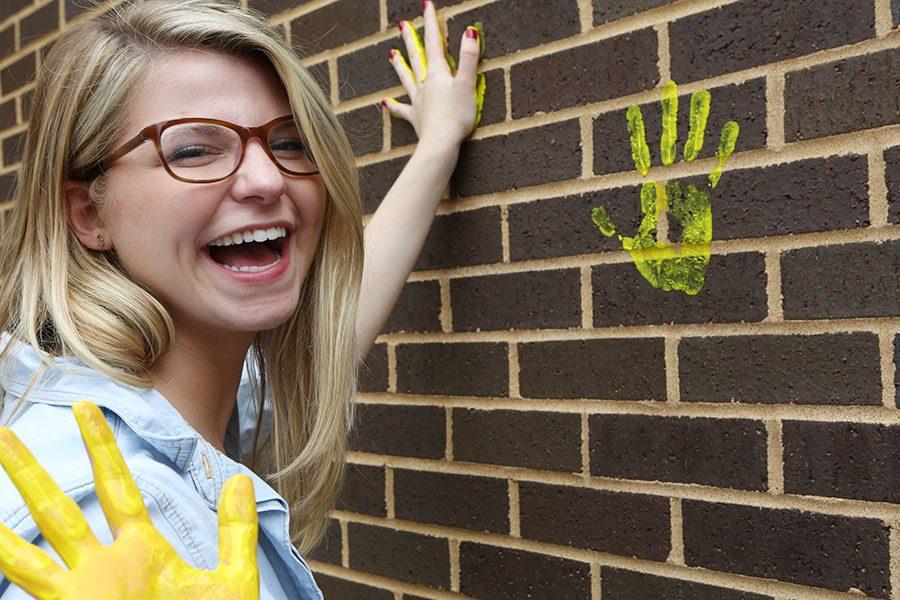 Lauren Rocca leaves her mark on the wall outside the EHS-hub, May 11.