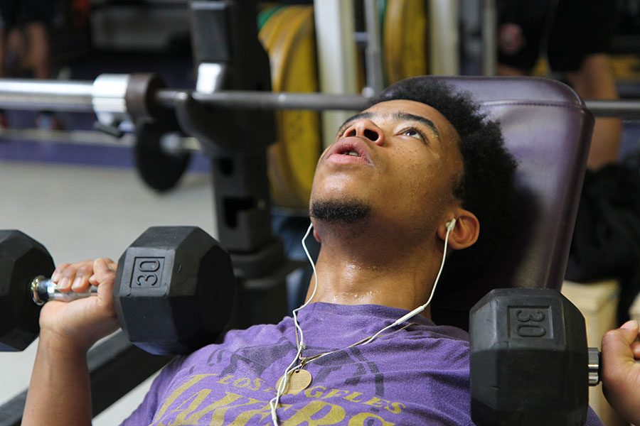 Stephon Watts (12) pumps the iron in weightlifting class, May 4