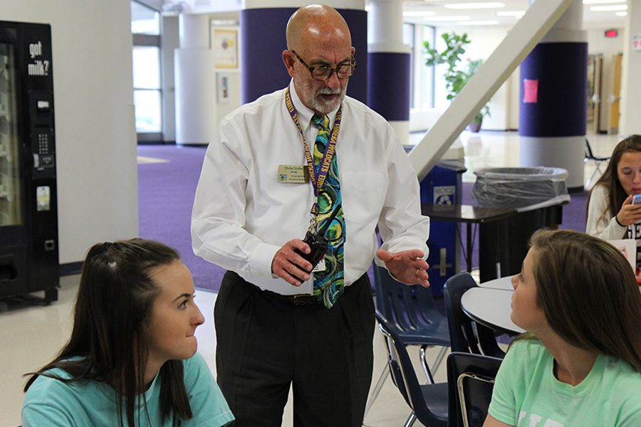 Mr. Crouther chats with Julia Bayless (11) and Ashley Jaspers (11) at second lunch, May 16.