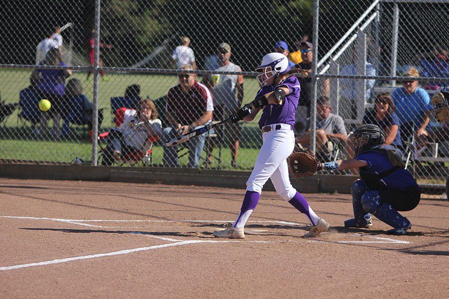 Kileigh Grisham, shortstop, makes contact during her at bat during the game against the Washington High School Bluejays, Aug. 22. The varsity softball team won, 5-4.