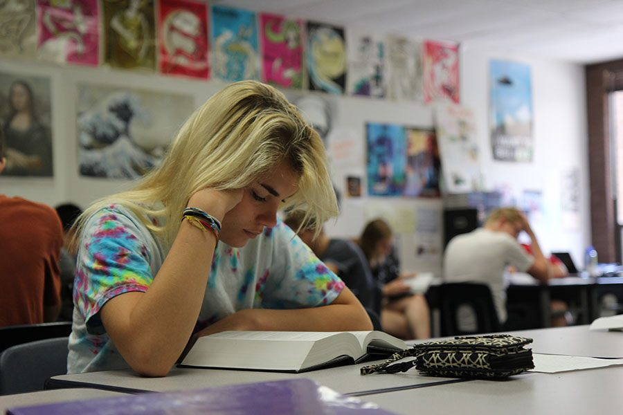 Sarah Ascrizzi (12) reads R.U.R. by  Karel Čapek in Mr. Gary Baumstarks 7th hour Science Fiction Literature class, Aug, 26. The class is really fun,” Ascrizzi said. “Mr. Baumstark is a great teacher just really interesting to learn about a different side of language arts than just reading normal books.”