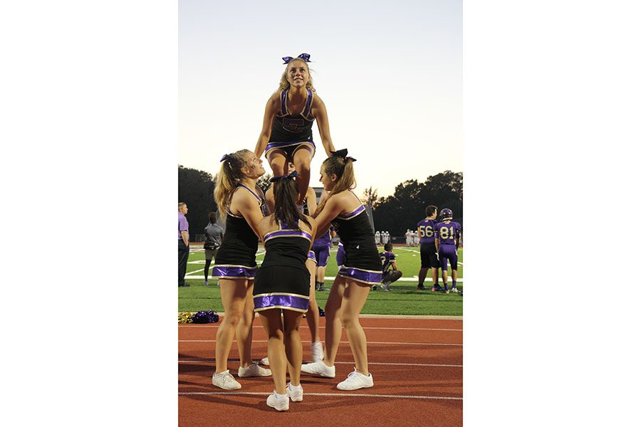 Sydney Tiemann, varsity cheer, rallies for the Wildcats at the Varsity football game against Parkway South, Sept. 23. “It’s just so fun standing in the line with the girls,” Tiemann said. “They are all so excited and fun to be with.”