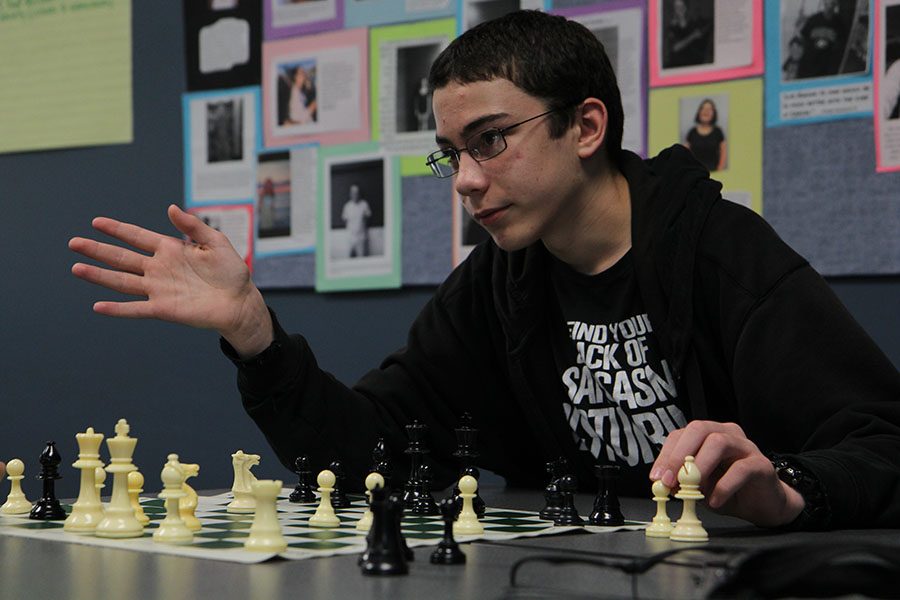 Reading his opponent, Michael Walka (9) makes a move in Chess Club during their meeting after school in the library’s Distance Learning Lab, Oct. 17. “It’s fun to play a strategy game like that,” Walka said. “It’s fun to win.”