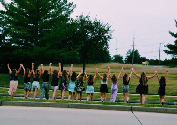 At the end of 8th grade, my best friends and I walk across the road hand-in-hand stepping into the next chapter of our lives. 