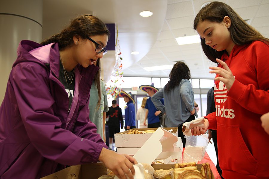 Bargaining over pastries, Layla Safi (11) negotiates the price of a pastry in Spanish with Jordan Hrabko (9) during the Spanish Market second hour, March. 27. “I choose to volunteer to be there to be able to use my spanish more, and interact with the younger students,” Safi said. “It was a lot of fun, just because I was able to use my Spanish from Spanish two and then being able to add more vocab that I know from Spanish 4.”