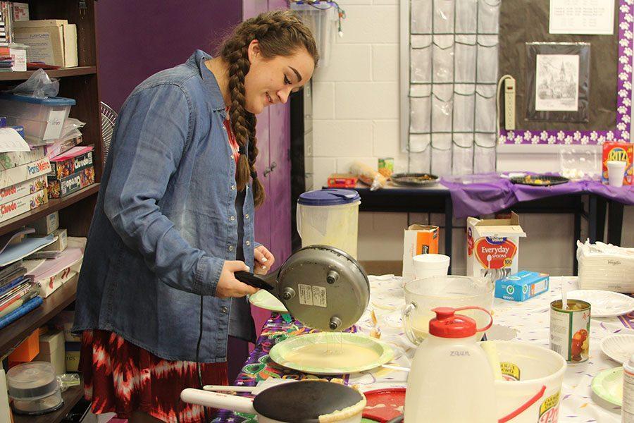 Batter cooking, Riley Andreasen (10) makes crepes during a Mardi Gras celebration in Jeanette Obergs seventh hour French 4 class, Feb. 28. “We got to learn about the holiday and what it means to the french people, I think that’s interesting,” Andreasen said. It relates to the Catholic Lent so Mardi Gras is a time to eat food you cant in a couple days. It is a day of celebration, food and joking around.