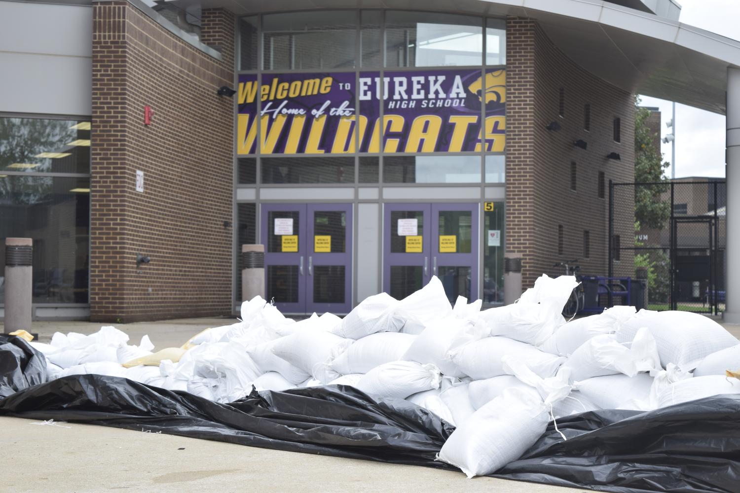 Volunteers prepare for the potential flooding of the school by stacking sandbags, April 30.