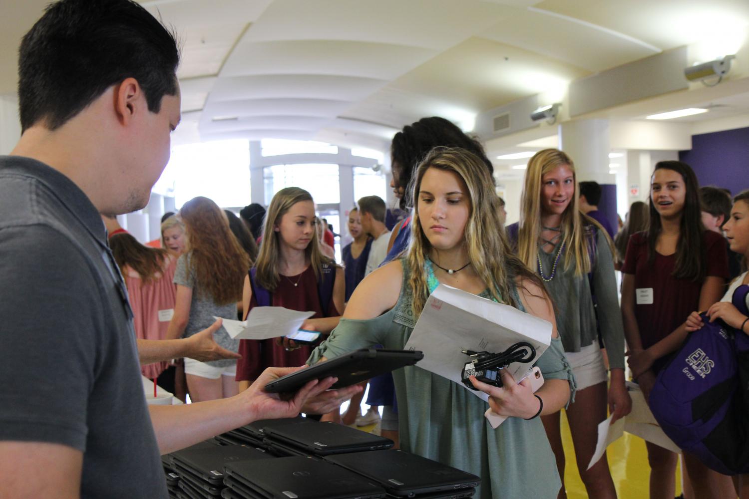 Fresh out of the box, Katelyn Hash (9) receives her brand new Chromebook in the Commons on Freshman Orientation, Aug 11. I wasnt nervous to get my Chromebook, Hash said. I use it to help me with math mostly since we have a program installed. 