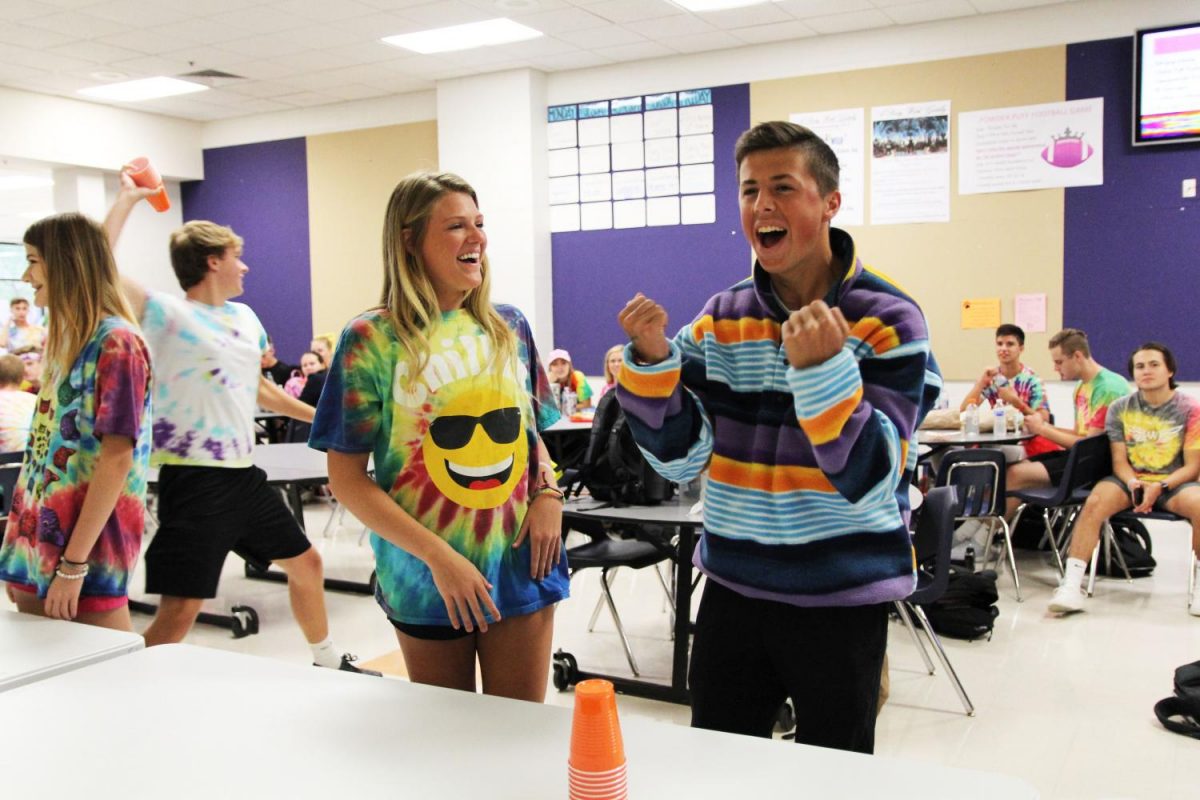 Cups stacked, Zoe Gustafson (11) and Nate Koenig (12) participate in lunchtime activities to earn points for the Junior class during Spirit Week, Oct. 3. 