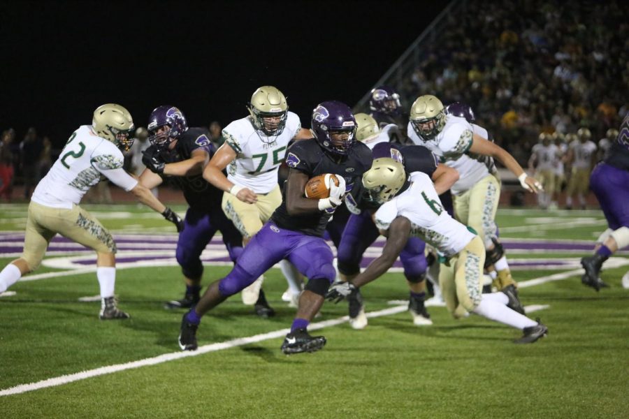 Hassan Haskins, running back/linebacker, carries the ball past Lindbergh, Oct. 6. I do my best when we play, Haskins said. I score a lot of touchdowns and gain a lot of yards. I play my part and do my role.” 
