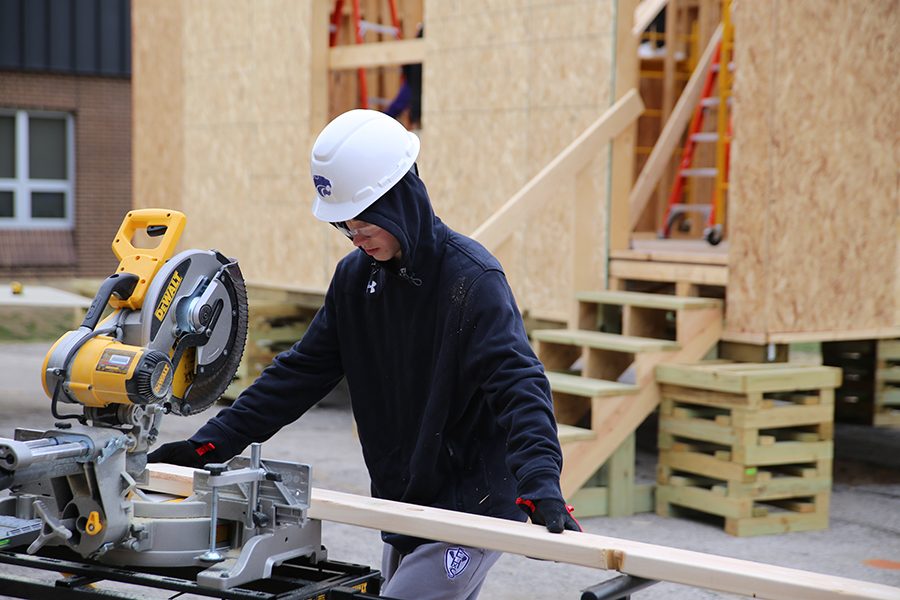 Winter temperatures dont stop Carson Estes (10)  from classwork as he cuts the rafters for the roof of a tiny home in Geometry in Construction, Dec. 14.