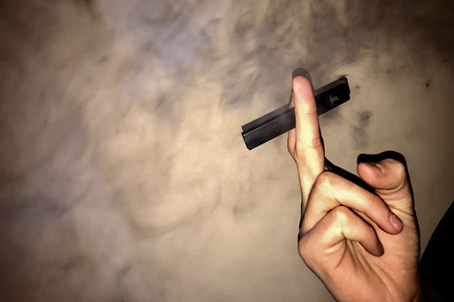 Smoke fills the air after a student inhales from a Juul, Jan. 6. 