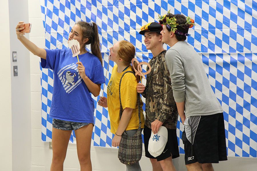 Jordan Thompson (12). Riley Schaefer (12), Bryan Howard (12) and Zach Walls (12)  capture the German culture around them at Rocktoberfest in the Commons, Oct. 3.