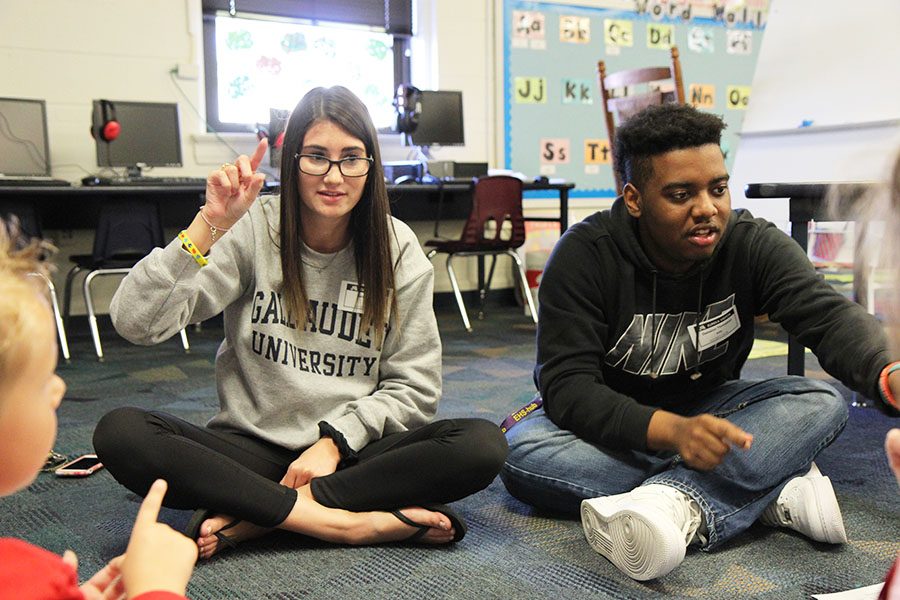 Alex DiPalma (12) and Dameion Thompson (11) help elementary school students to learn American Sign Language at Eureka Elementary, Oct. 17.