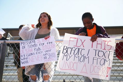 Grace Eickel and Sophana Holdegraver (12) hold up signs during the EHS walkout, April 20. 