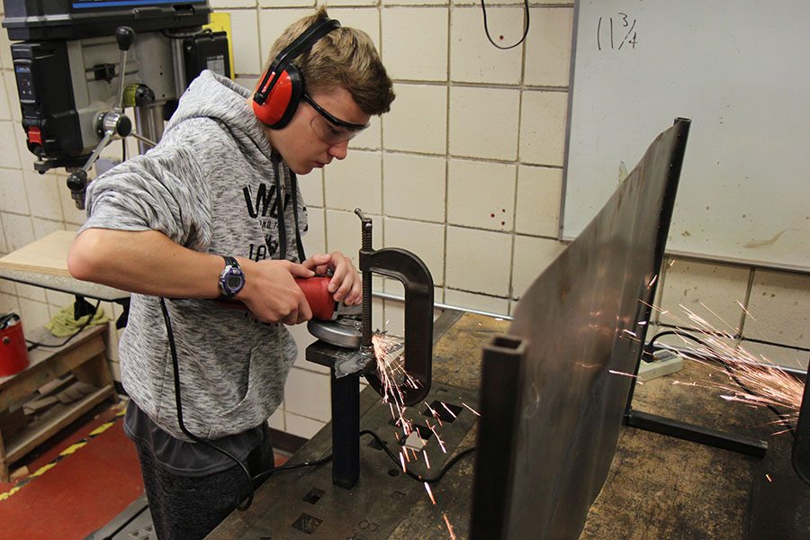 Grinder in hand, Bryan Christensen (9) smoothes out his weathervane during during David Luecke’s first hour Metals 1 class, Oct. 11. “I like Metals because it is hands on,” Christensen said. “There is no busy work and you are always working on something you can see. It is creative. You can use tools you are not used to. It is an outlet because you aren’t just sitting down and working on a worksheet or taking notes. You move everyday.”