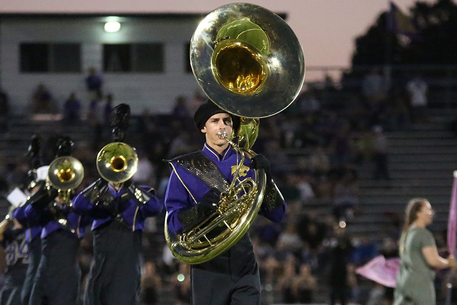 Ethan Schweizer, tuba, marches at halftime during a football game, Aug. 24.