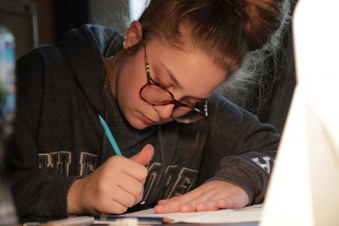 Erasing her paper, Jessica Smegner (10) works on her still-life project in Kristina Welch’s sixth hour Art Fundamentals class, Feb. 21. “I don’t really enjoy art,” Smegner said. “I am just taking it because it is required. I like history and science, those are my two favorites. I don’t like working on my still-life especially when the lights are off. It makes me tired.” 