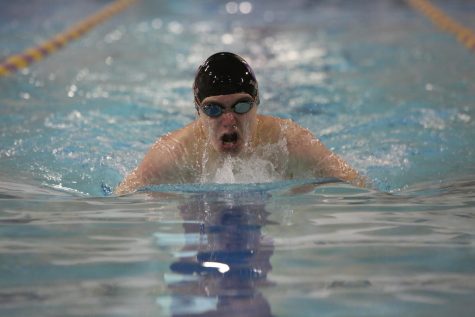 Coming up from the water, Rowan Peckham (11) races in the varsity swim meet against CBC, October 22. Wildcats won 97-89.