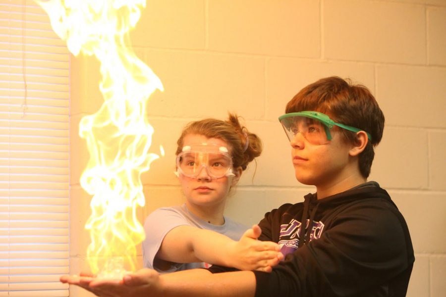 Flames in the air, William Conley (10) and Grace Martin (12) participate in Mole Day, October 24. “Grace ignited propane bubbles in my hands,” Conley said. “For Mole Day, we did lots of experiments. It was very fun. However, my favorite part of Mole Day was the food party we had afterwards.”