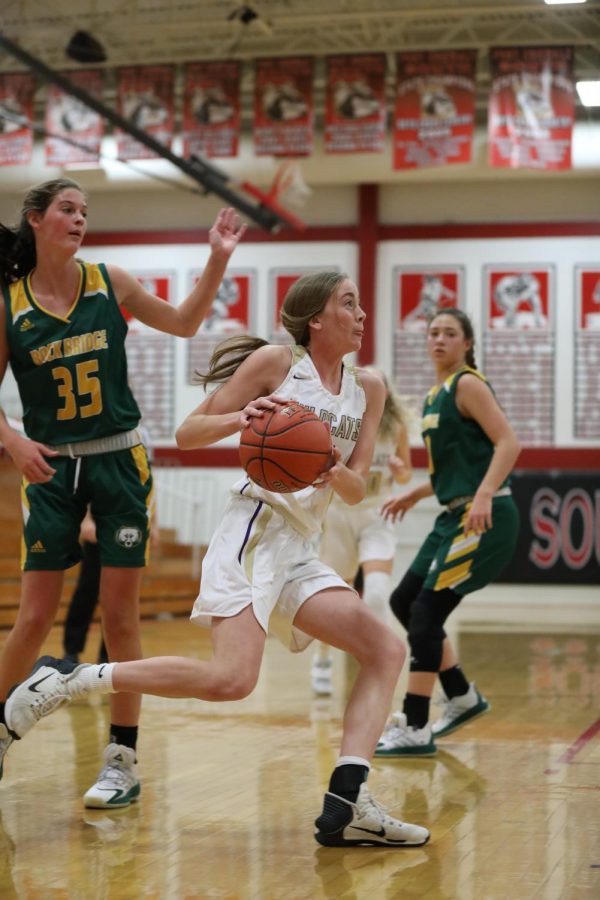 Kendall Bauer runs past her opponents at the JV basketball game against Rock Bridge, December 3. 