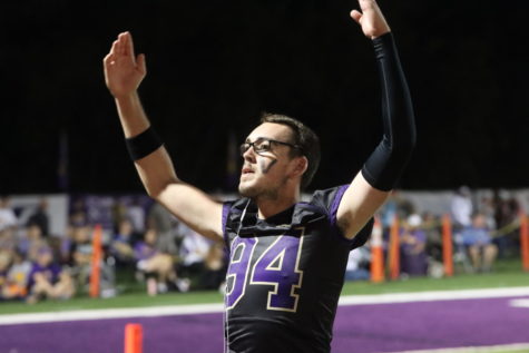 Aidan Valentine celebrates the Wildcats from the sidelines. 
