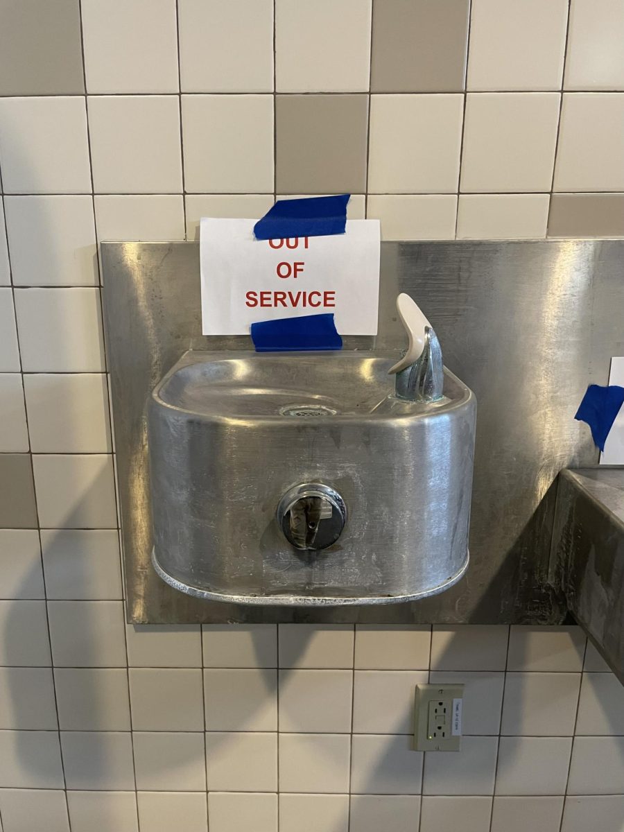 Water fountain in room E129 with “out of service” sign marked by SCI Engineering. 