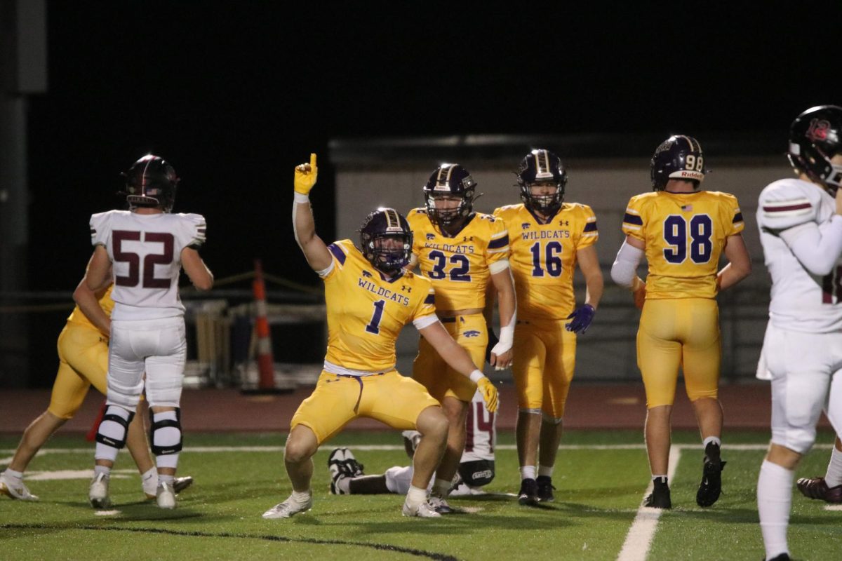 Following a big tackle for loss, senior Blake Ashby celebrates on the field. 