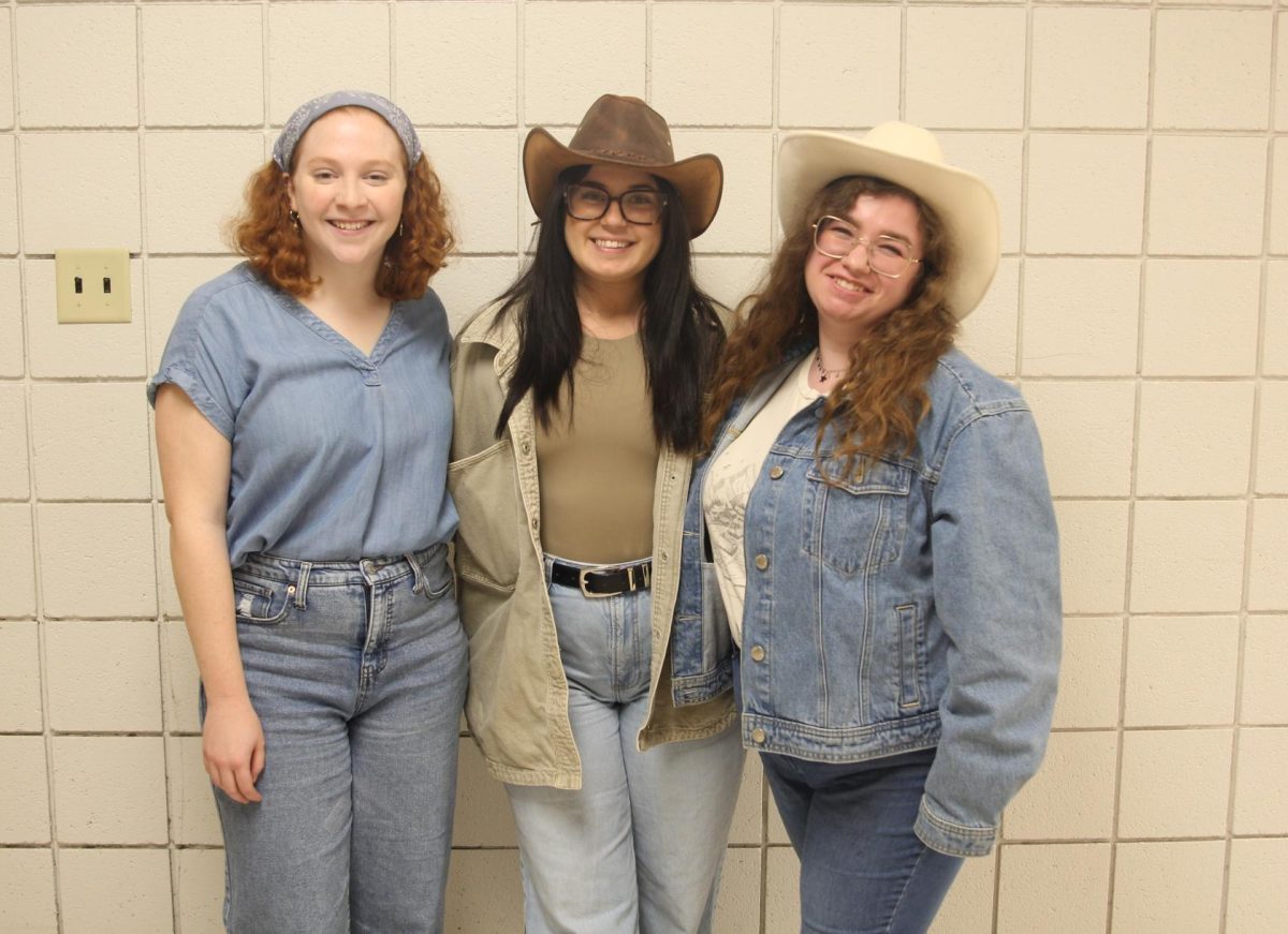 Grace Daugherty,  Jordan Cushman, and Mary Green pose in their spirit day outfits.