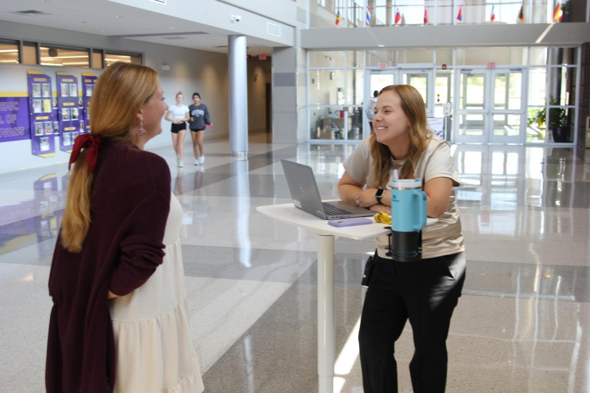 Ms. Sarah Goodman interacts with staff while utilizing her mobile office