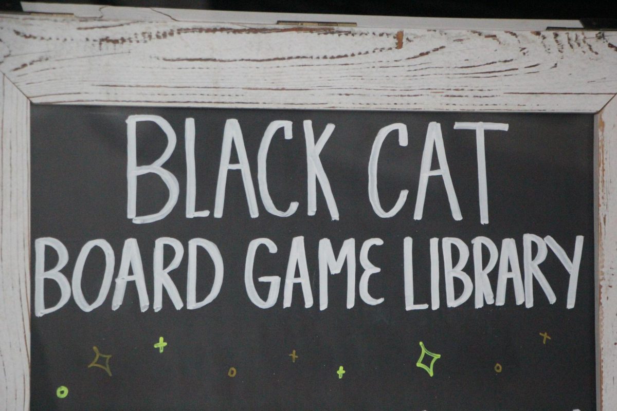 Chalk board displayed  in Black Cat's window