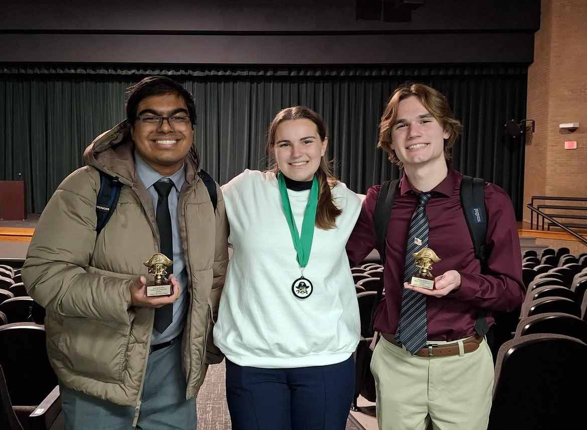 Members of Speech and Debate pose proudly with their medals after a competition.