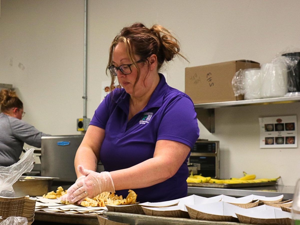 Child Nutritionist Amber Diercks demonstrating the process of making school lunch.