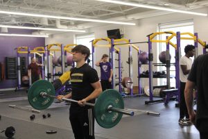 Student in Advanced Lifting doing bicep curls.