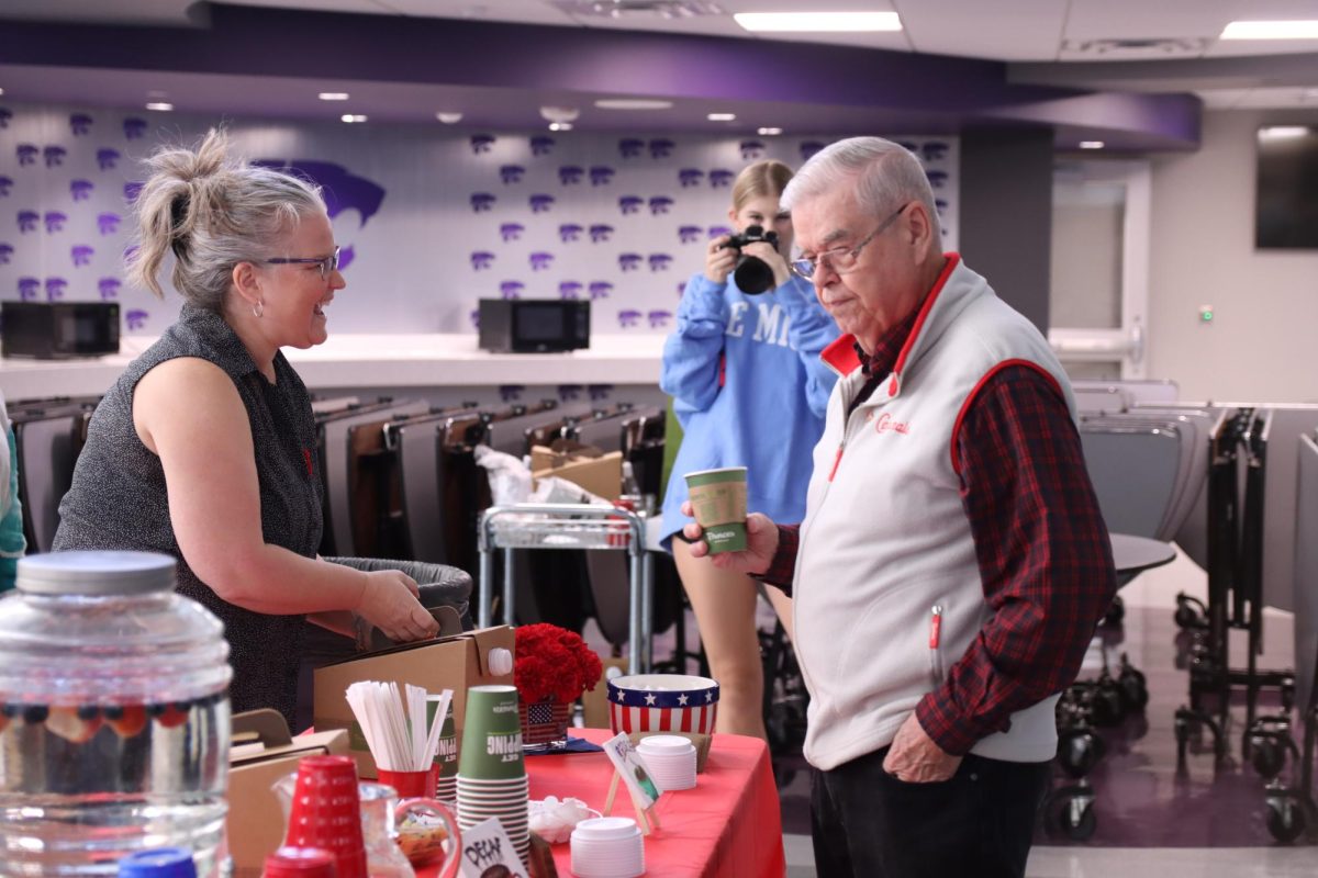 Veteran interacts with helper at Veterans breakfast