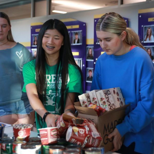Stucco members helping sort cans at annual canned food drive.